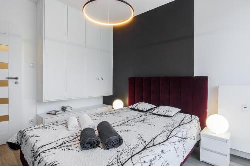 a bedroom with a bed with two towels on it at NovumApartamenty in Kołobrzeg