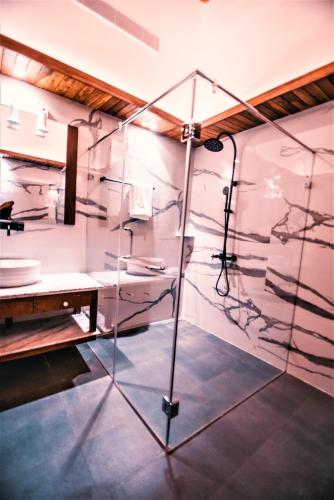 a glass display case in a room with a sink at Symphony Samudra Beachside Jungle Resort And Spa in Port Blair
