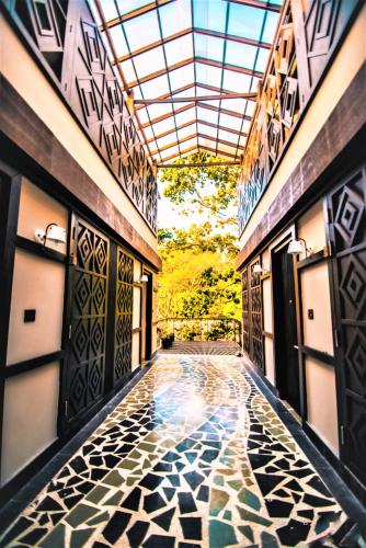 a hallway of a building with a tile floor at Symphony Samudra Beachside Jungle Resort And Spa in Port Blair