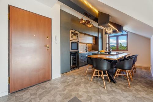 a kitchen and dining room with a table and chairs at Infinity Sky Zlatibor in Zlatibor