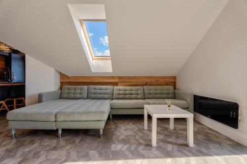 a living room with a couch and a table at Infinity Sky Zlatibor in Zlatibor