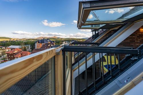 a balcony with a view of a city at Infinity Sky Zlatibor in Zlatibor