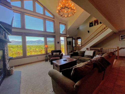 a living room with couches and a large window at M1 Luxury home a short walk from the Mount Washington Hotel AC heated floor stunning views in Carroll