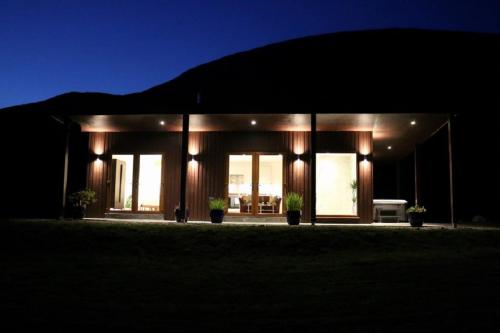 a house lit up at night with lights at Frances' Sketch Pad with Hot Tub in Fort William