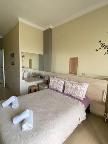 a bedroom with a large bed with towels on it at Alexander Apartments in Alexandroupoli
