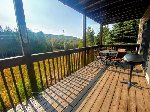 a screened in porch with a table and chairs at S4 Ski Slope Views Bretton Woods condo with easy access to Mt Washington Skiing White Mountains in Carroll