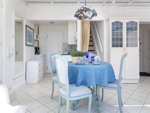 a dining room with a blue table and chairs at Ferienwohnung Scheunemann in List