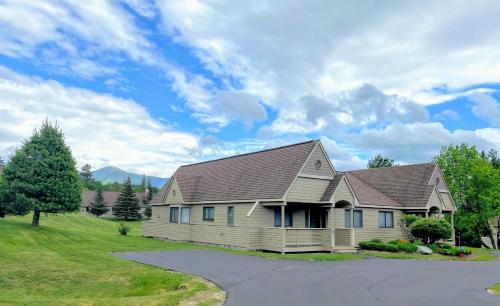 a house with a gambrel roof and a driveway at F4 Warm Fairway Village Townhome mountain views and large lawn So much to do in Carroll