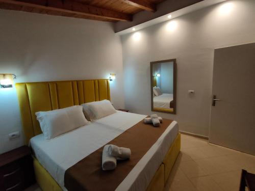 a bedroom with a large bed with towels on it at Vila Bello in Ksamil