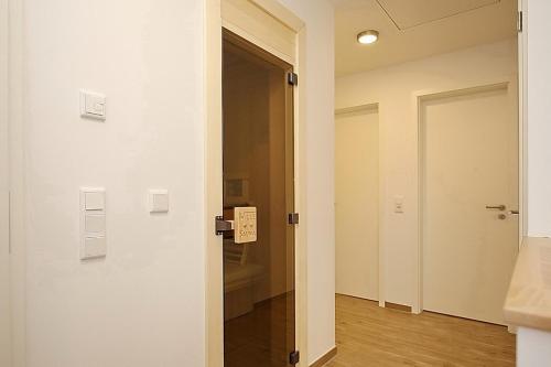 a door with a sign on it in a room at Reethaus Am Mariannenweg 04a in Boltenhagen