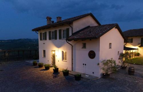 a white house with a light on it at night at Locanda Del Pilone in Alba