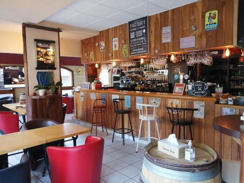 een restaurant met een bar met tafels en stoelen bij Le Grand Chatelard HÔTEL BAR RESTAURANT in Sainte-Marie-de-Cuines
