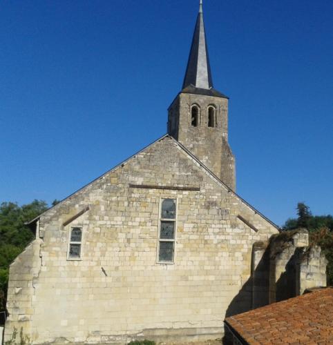 an old brick church with a steeple on top at The Piggeries at La Maison Tumtum Arbre in Loudun