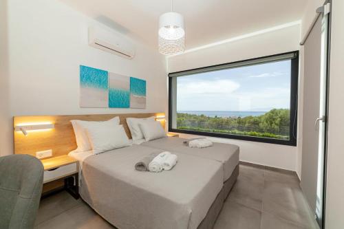 Vuode tai vuoteita majoituspaikassa Merelia Luxury Villas - Halkidiki