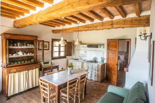 a kitchen with a table and a counter top at Agriturismo Pieve Sprenna in Buonconvento