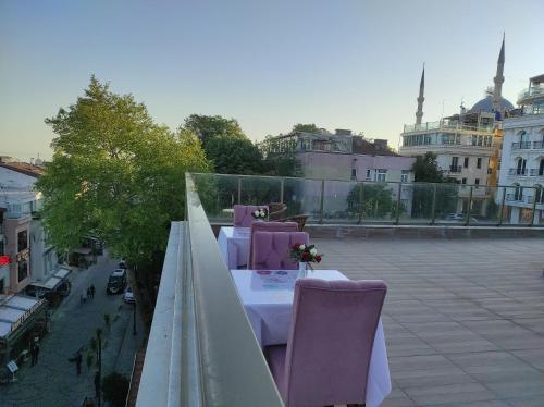 a balcony with a table and chairs on a roof at Magnaura House Hotel in Istanbul