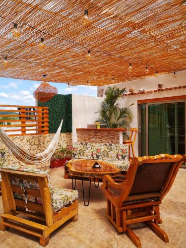 a living room with a couch and a hammock at Hotel Malibu in San Juan Nepomuceno
