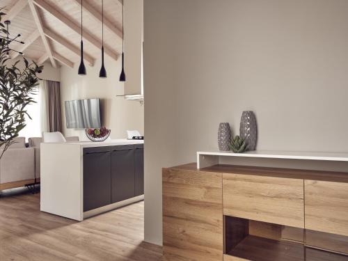 a kitchen with white walls and wooden floors at Villa Fabiana in Kipseli