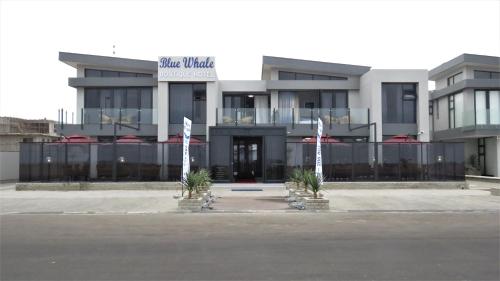 a building with a sign that reads blue whale at Blue Whale Hotels in Walvis Bay