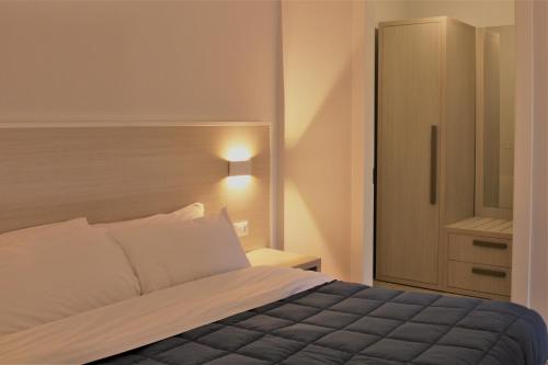 a bedroom with a bed and a cabinet in it at Zibibbo Beach Apartments - Trapani in Trapani