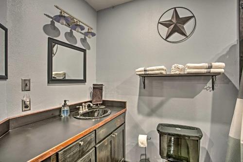 a bathroom with a sink and a mirror at Charming Quitman Cabin Less Than 2 Miles to Lake Fork in Quitman