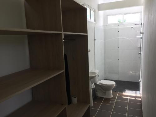 a bathroom with a toilet and a glass shower at Finca La Ranchera No. 2 in Tarso
