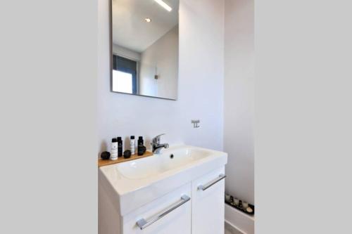 a bathroom with a sink and a mirror at WONDERFUL ECO FRIENDLY VILLA AUGUSTINE in Ambelón