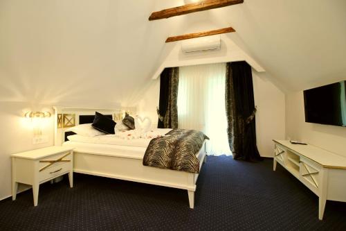 a bedroom with a white bed with a large window at Casa Hermanni in Sibiu