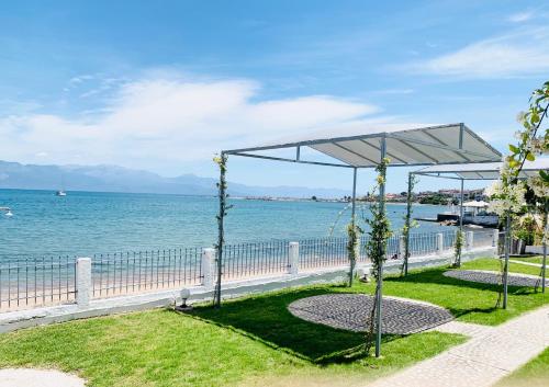 a wedding ceremony on the beach near the water at Seaside Bungalows Petalidi in Petalidhion