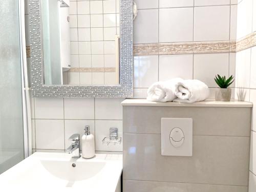a bathroom with a sink and a mirror at Apartments Erceg in Makarska
