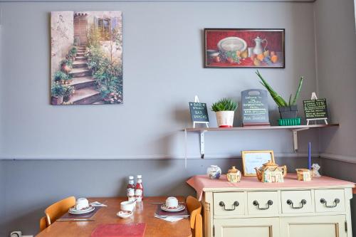 a dining room with a table and a table and a picture at The Wilton International in Blackpool