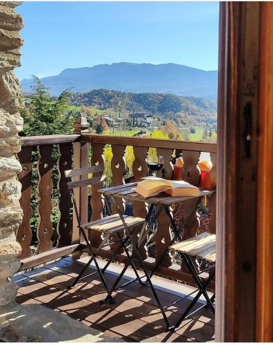 a table on a balcony with a book on it at Mas D'en Roqueta in Aravell