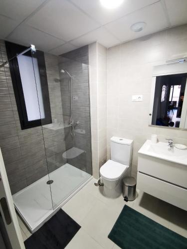 a bathroom with a shower and a toilet and a sink at Superior Calpe Pearl Beach in Calpe