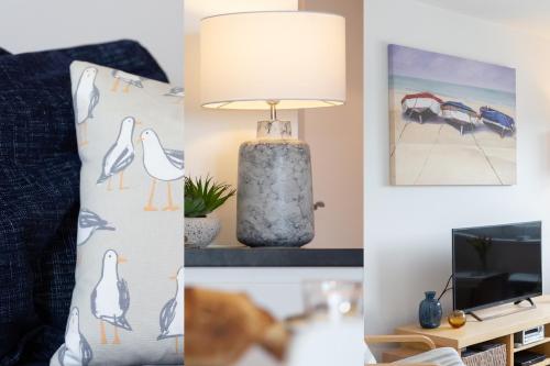 a living room with a lamp and a bed and a tv at 35 Carrack Widden in St Ives
