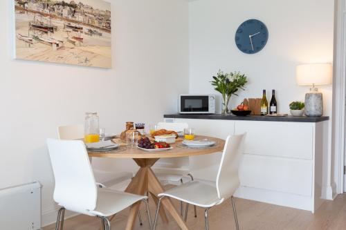 a dining room with a table with a plate of food at 35 Carrack Widden in St Ives