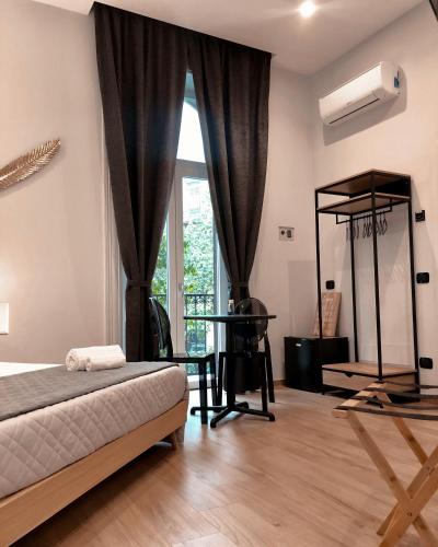 a bedroom with a bed and a window and a desk at B&B Angolo83 Palermo centro in Palermo