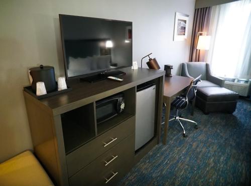 a hotel room with a desk and a television at Best Western Carlisle South in Carlisle