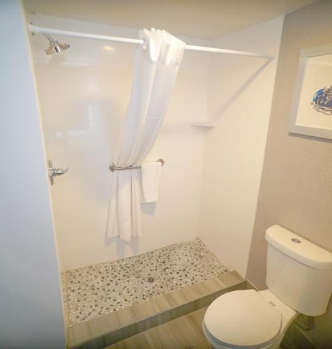 a white bathroom with a toilet and a shower at Best Western Carlisle South in Carlisle