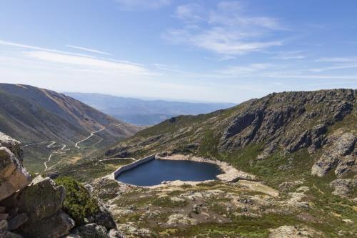 a crater lake on the side of a mountain at Luna Chalets da Montanha - Serra da Estrela in Covilhã