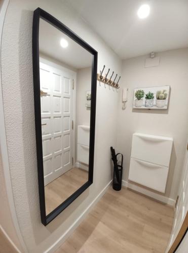 a mirror in a hallway with a white door at Apartamento Casa Bielsa in El Pueyo de Jaca