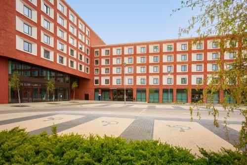 an empty courtyard in front of a building at Novotel Cambridge North in Cambridge