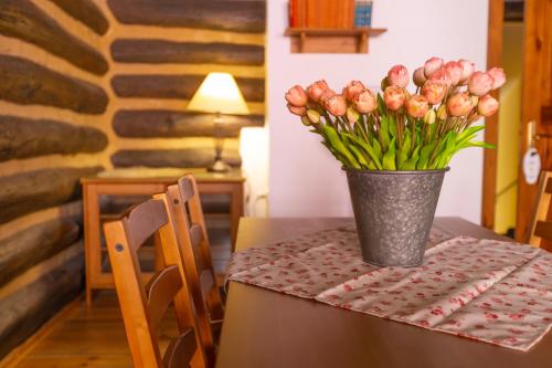 a vase of pink tulips sitting on a table at Penzion U Hrádku in Kutná Hora