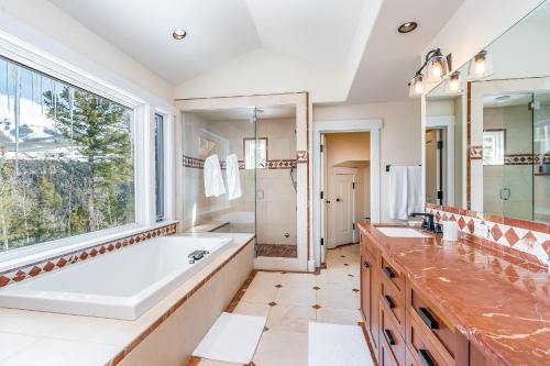 a bathroom with a tub and a large window at Adams Ranch Rd - 247 in Telluride