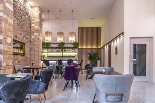 a restaurant with chairs and tables and a bar at Philia Boutique Hotel in Athens