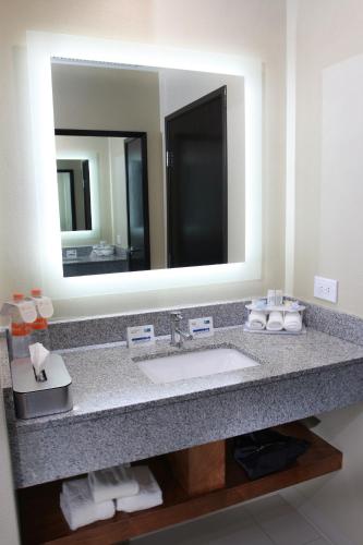 a bathroom with a sink and a large mirror at Holiday Inn Express & Suites Mexicali by IHG in Mexicali