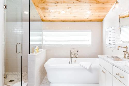 a white bathroom with a tub and a sink at Boulders Way - 15 in Telluride