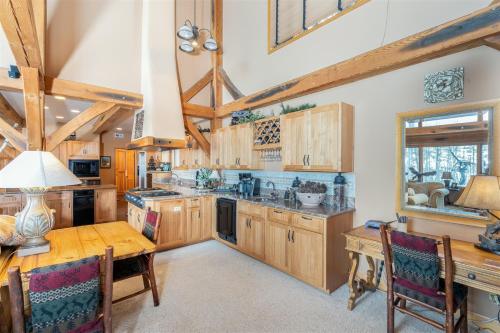 a kitchen with wooden cabinets and a wooden table at Double Eagle Way 102 in Telluride