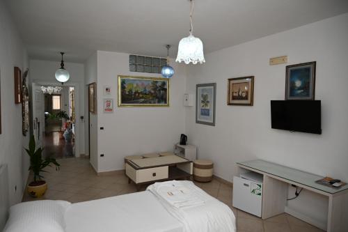 a room with a bed and a desk in it at Aparthotel Shkodra in Durrës
