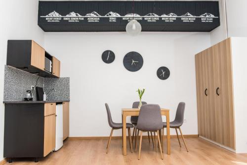 a kitchen and dining room with a table and chairs at Penzión Branecky in Trenčín