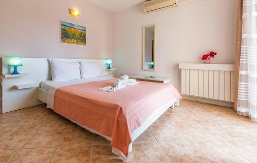 a bedroom with a bed with a red blanket at Villa San Rocco Bed & Breakfast in Medulin